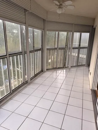 a view of a white house with a big yard and large tree