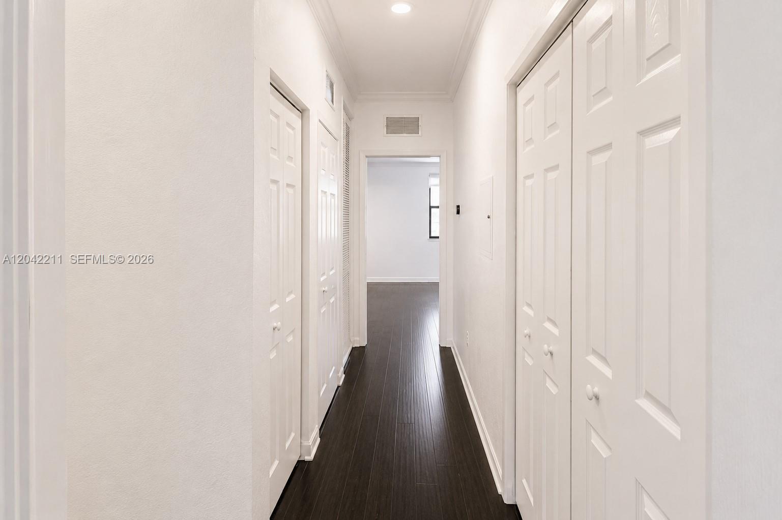 8954 West 35th Way Hialeah, FL 33018 - Photo 12 of 24 a view of a hallway with a wooden door