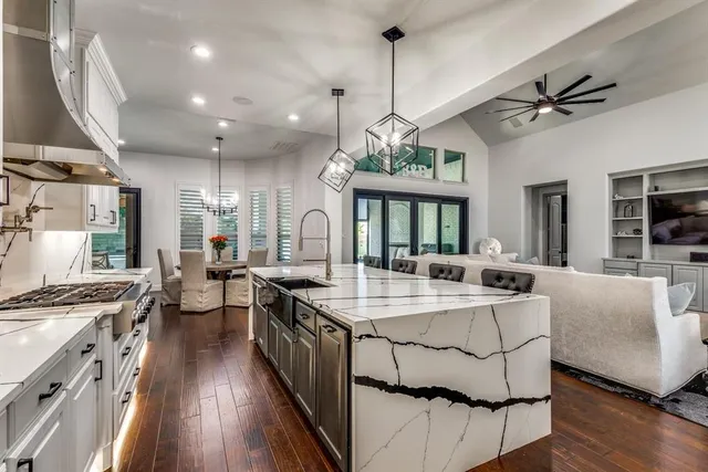 a large kitchen with a table and chairs
