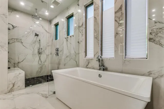 a bathroom with a bathtub and a shower