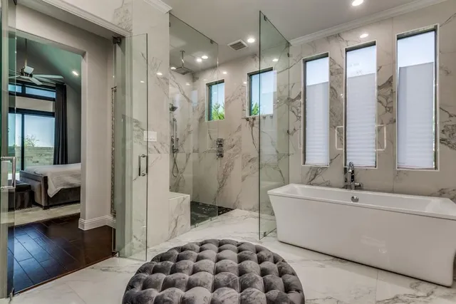 a spacious bathroom with a bathtub shower and sink