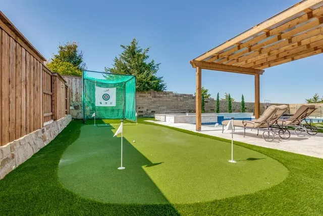a view of a backyard with swimming pool