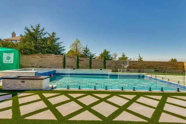 a view of backyard with swimming pool and outdoor seating