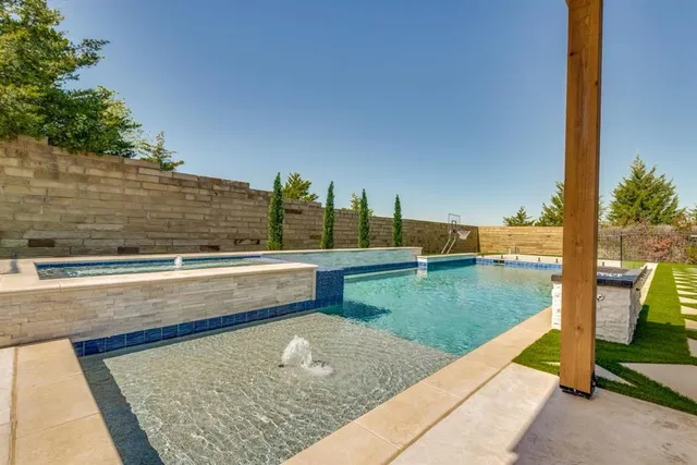 a view of swimming pool with a lounge chairs