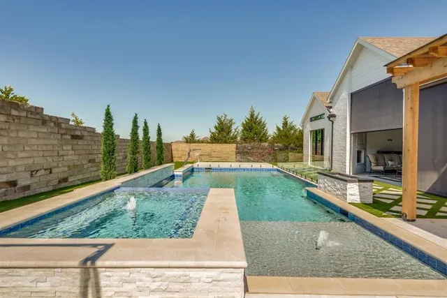 a view of swimming pool with a lounge chairs
