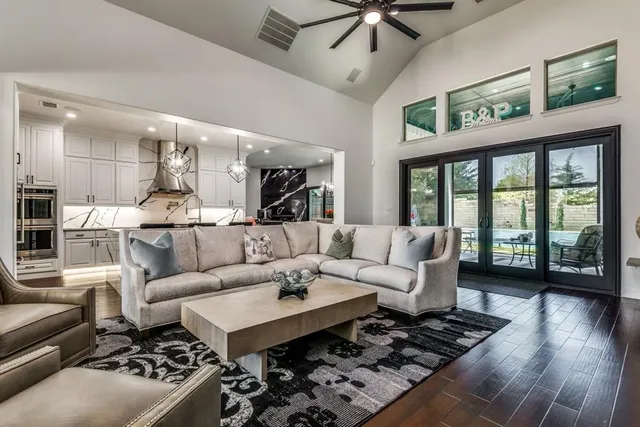 a living room with furniture ceiling fan and a rug