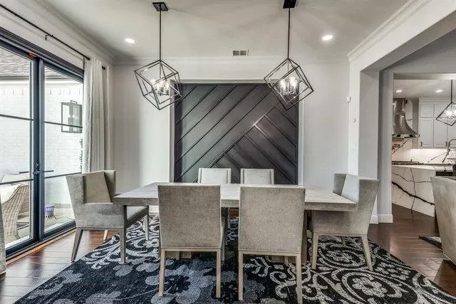 a view of a dining room with furniture wooden floor and chandelier