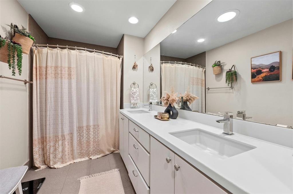 2802 Warren Street, Unit A Austin, TX 78703 - Photo 20 of 29 a bathroom with a double vanity sink and a mirror