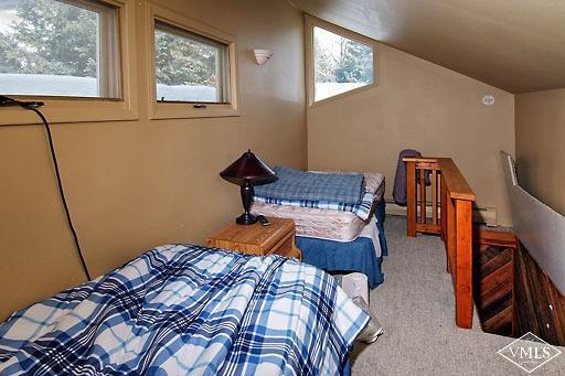 907 Red Sandstone Road, Unit 9C Vail, CO 81657 - Photo 4 of 7 a bedroom with a bed and wooden floor