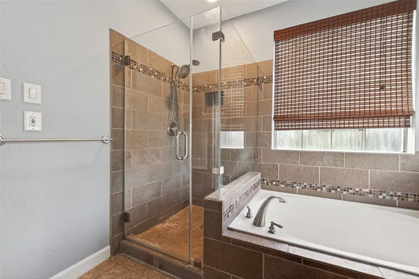 a bathroom with a bathtub and a shower