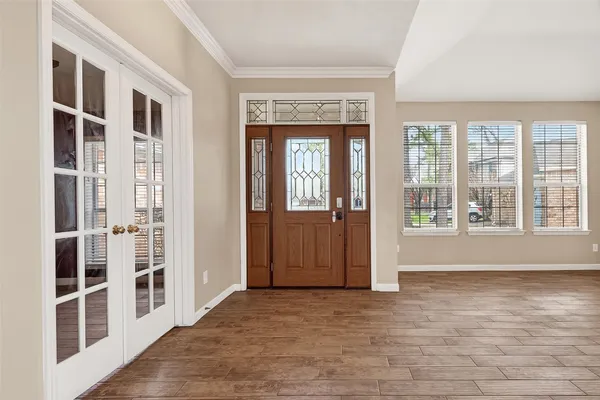 a view of an entryway with wooden floor and windows