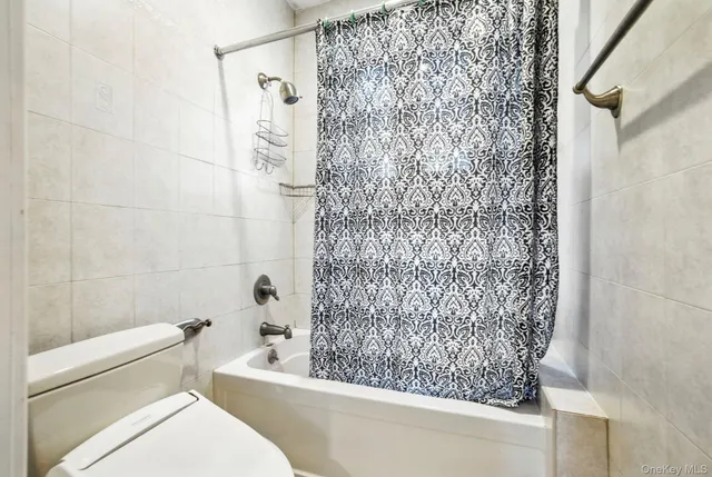 a bathroom with a toilet and shower