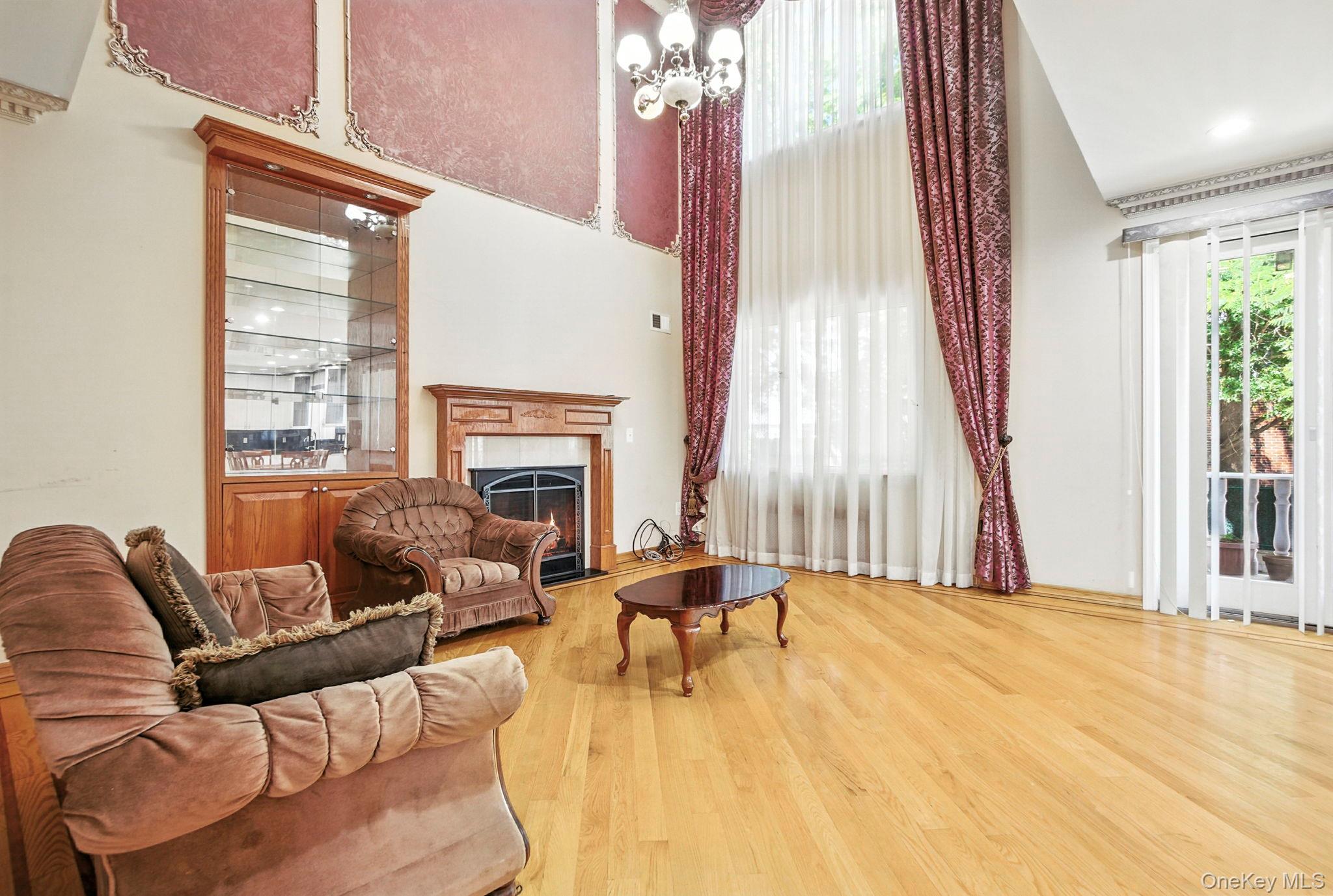 77-16 Kew Forest Lane Queens, NY 11375 - Photo 2 of 28 a living room with furniture and a fireplace