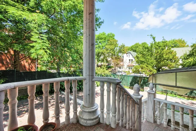 a front view of a house with a yard and potted plants