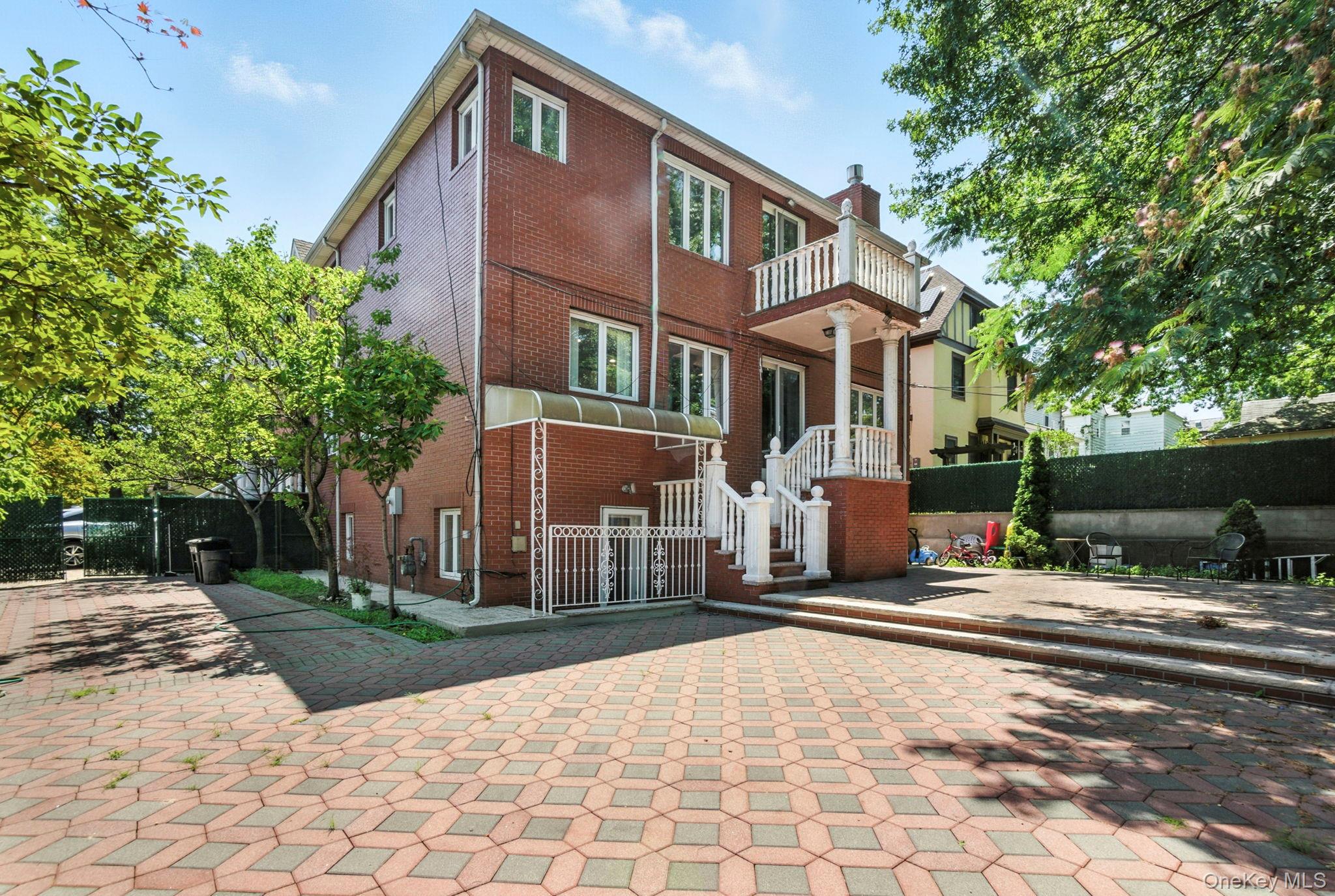 77-16 Kew Forest Lane Queens, NY 11375 - Photo 26 of 28 a front view of a house with a yard and potted plants