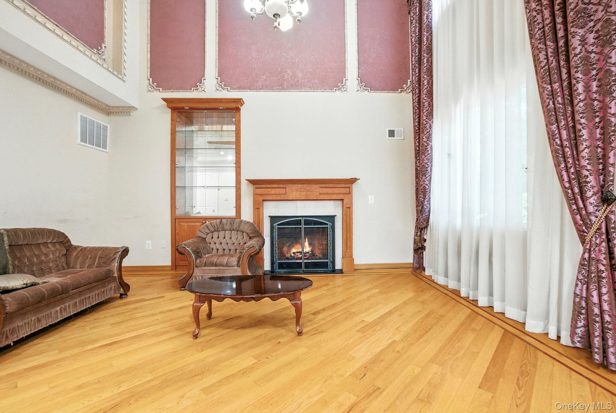 77-16 Kew Forest Lane Queens, NY 11375 - Photo 3 of 28 a living room with furniture and a fireplace