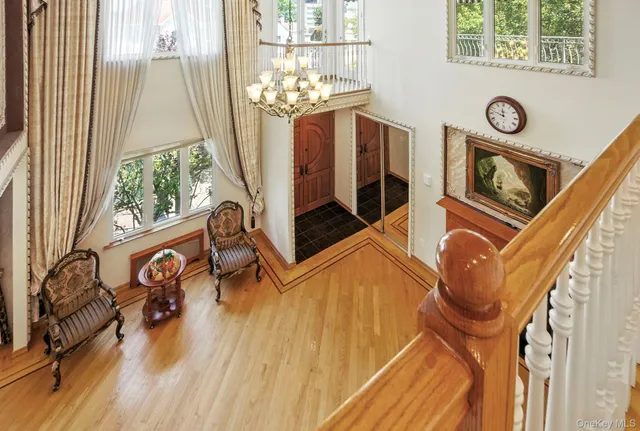 a view of a room with wooden floor and windows