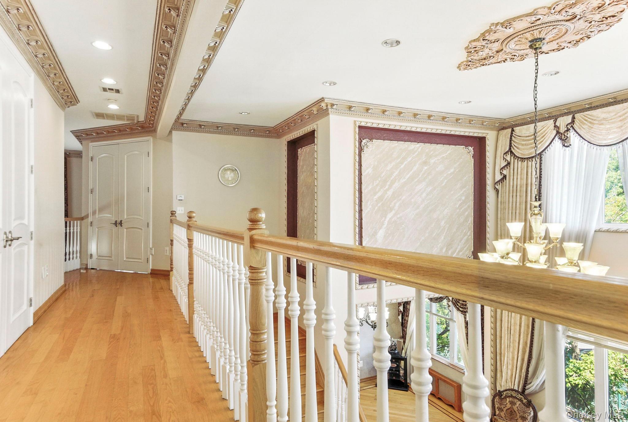 77-16 Kew Forest Lane Queens, NY 11375 - Photo 6 of 28 a view of a hallway with wooden floor and staircase