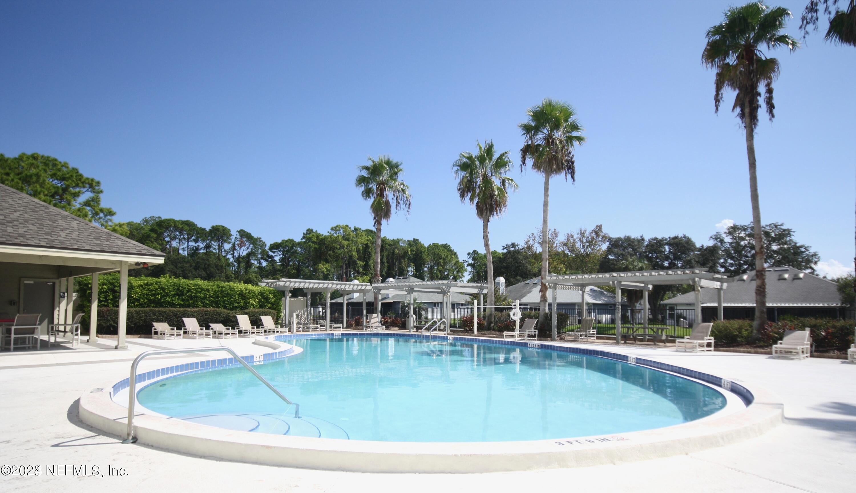 2012 Sea Hawk Circle Ponte Vedra Beach, FL 32082 - Photo 12 of 13 a view of a swimming pool with a table and chairs