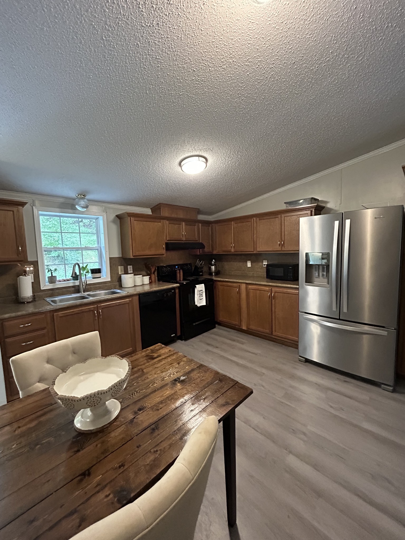 1100 Happy Valley Road Buffalo Valley, TN 38548 - Photo 13 of 27 a kitchen with stainless steel appliances wooden floor and wooden floor