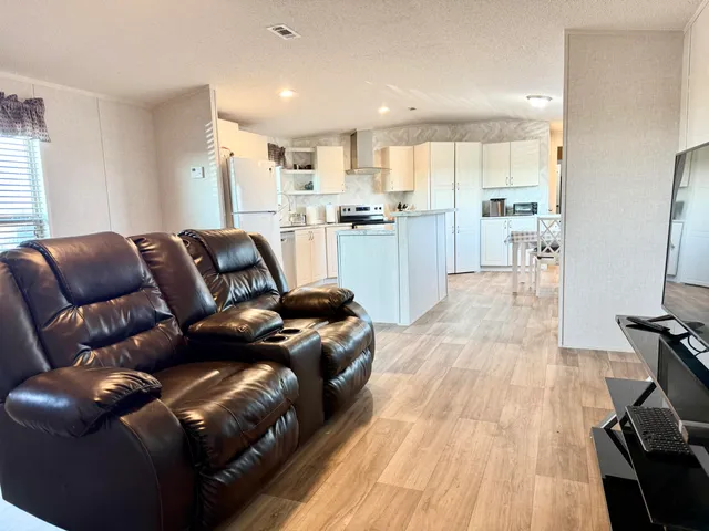 a living room with a couch and a wooden floor