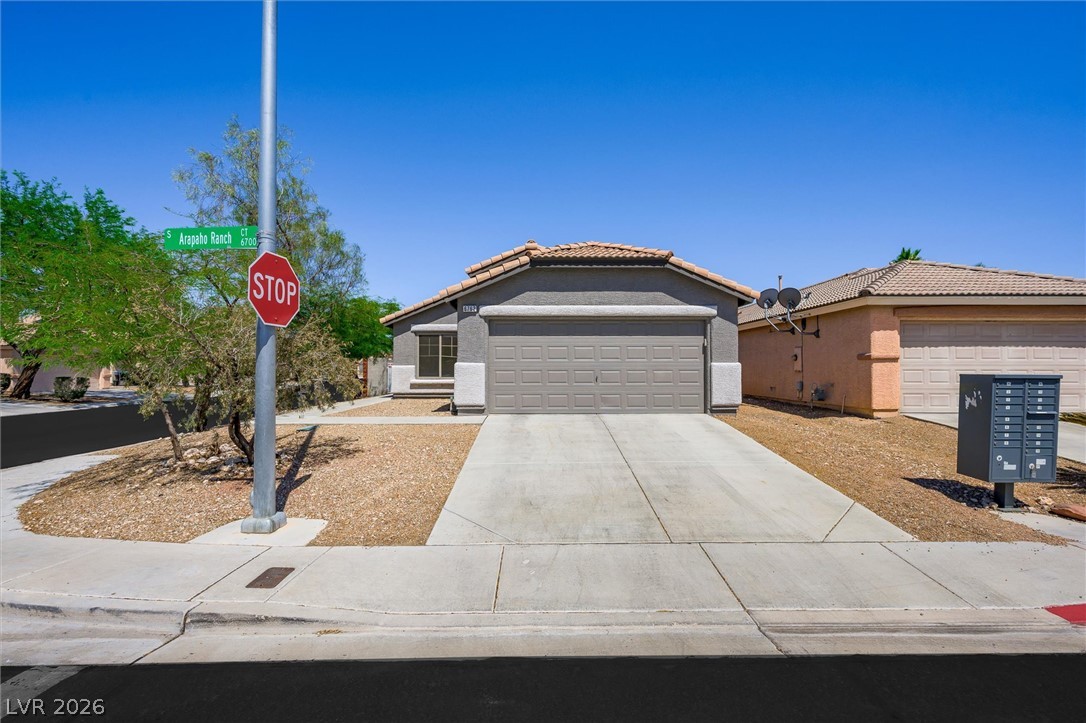 6762 Arapaho Ranch Las Vegas, NV 89148 - Photo 1 of 27 A well-maintained facade with an attached garage offers appealing curb appeal.