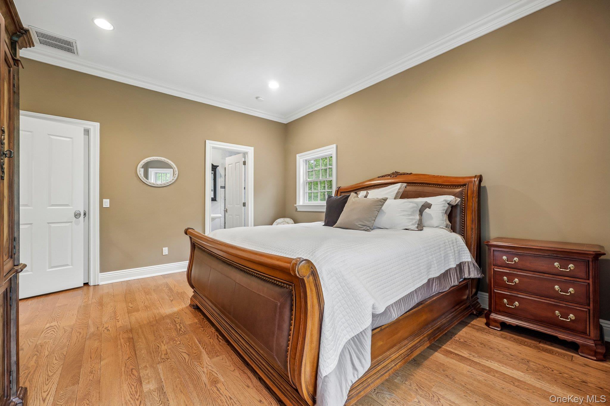 5 Mill Road Lloyd Harbor, NY 11743 - Photo 39 of 49 a spacious bedroom with a bed and wooden floor
