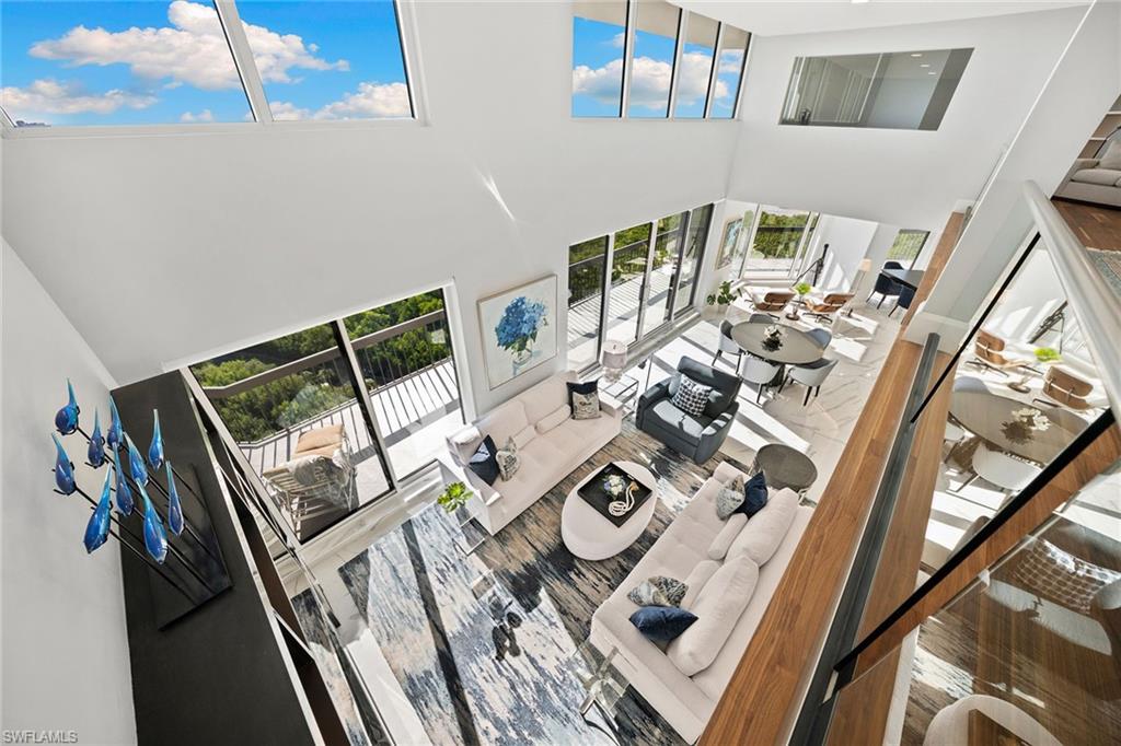 6001 Pelican Bay Boulevard, Unit PHA Naples, FL 34108 - Photo 14 of 50 a view of living room and dining room with furniture