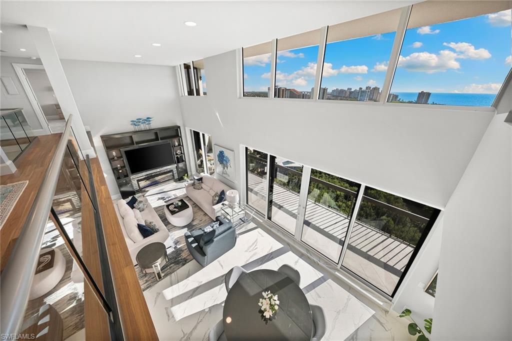 6001 Pelican Bay Boulevard, Unit PHA Naples, FL 34108 - Photo 15 of 50 a view of living room with furniture and flat screen tv