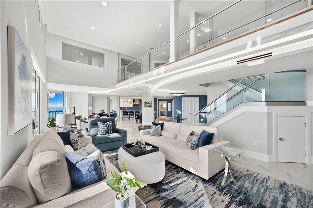 6001 Pelican Bay Boulevard, Unit PHA Naples, FL 34108 - Photo 17 of 50 a living room with furniture and wooden floor