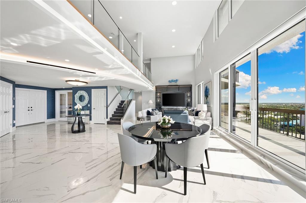 6001 Pelican Bay Boulevard, Unit PHA Naples, FL 34108 - Photo 19 of 50 a kitchen with a table and chairs in it