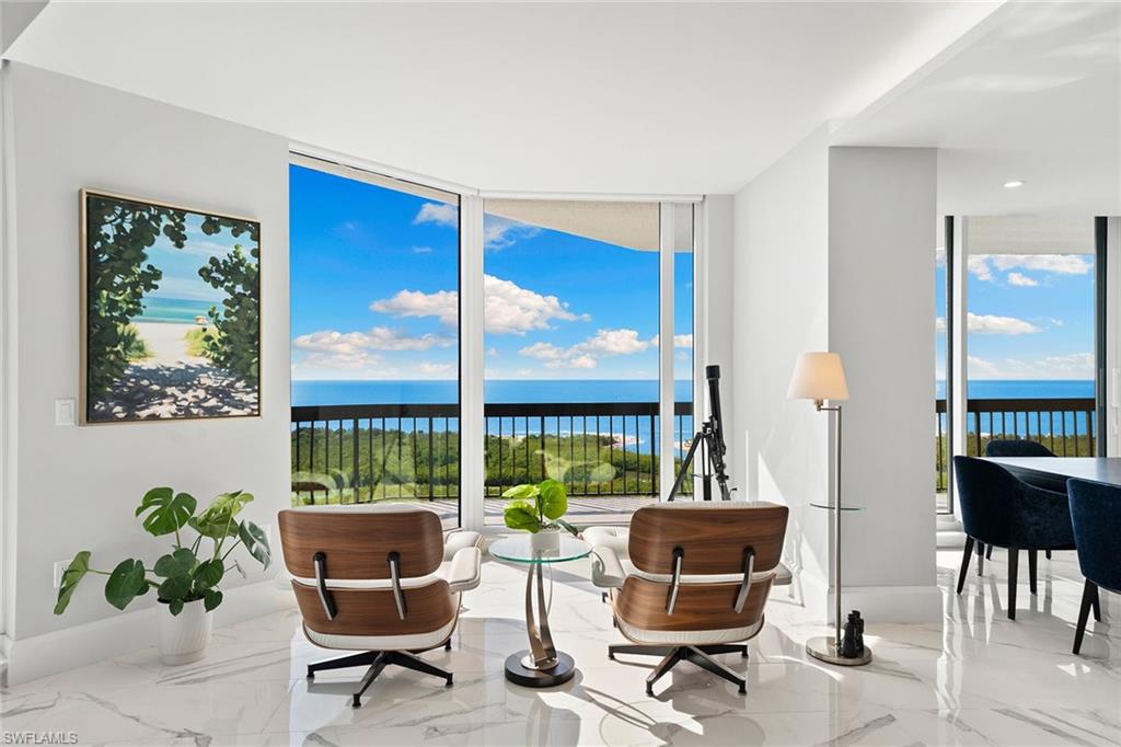 6001 Pelican Bay Boulevard, Unit PHA Naples, FL 34108 - Photo 22 of 50 a view of a livingroom with furniture and a window