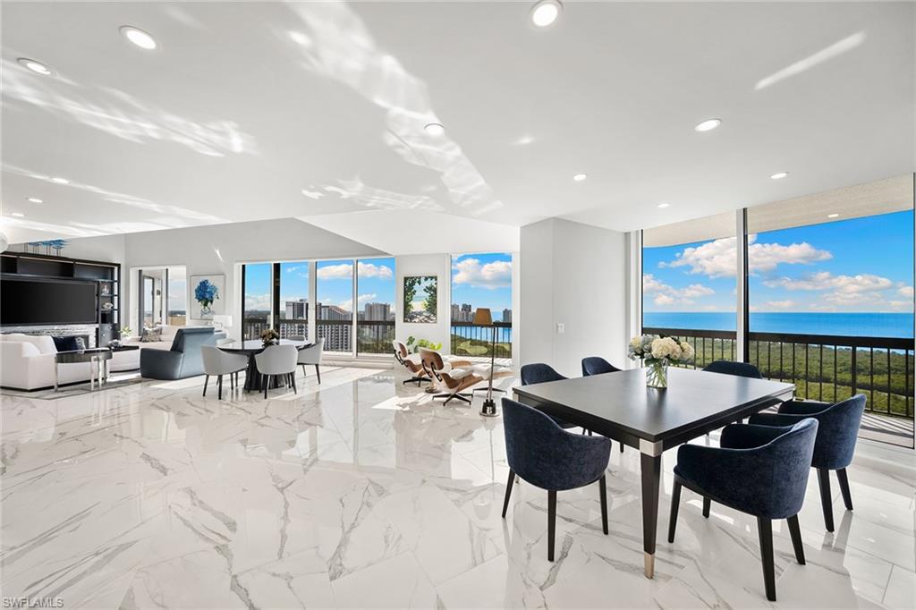 6001 Pelican Bay Boulevard, Unit PHA Naples, FL 34108 - Photo 23 of 50 a view of a dining room with furniture and a floor to ceiling window