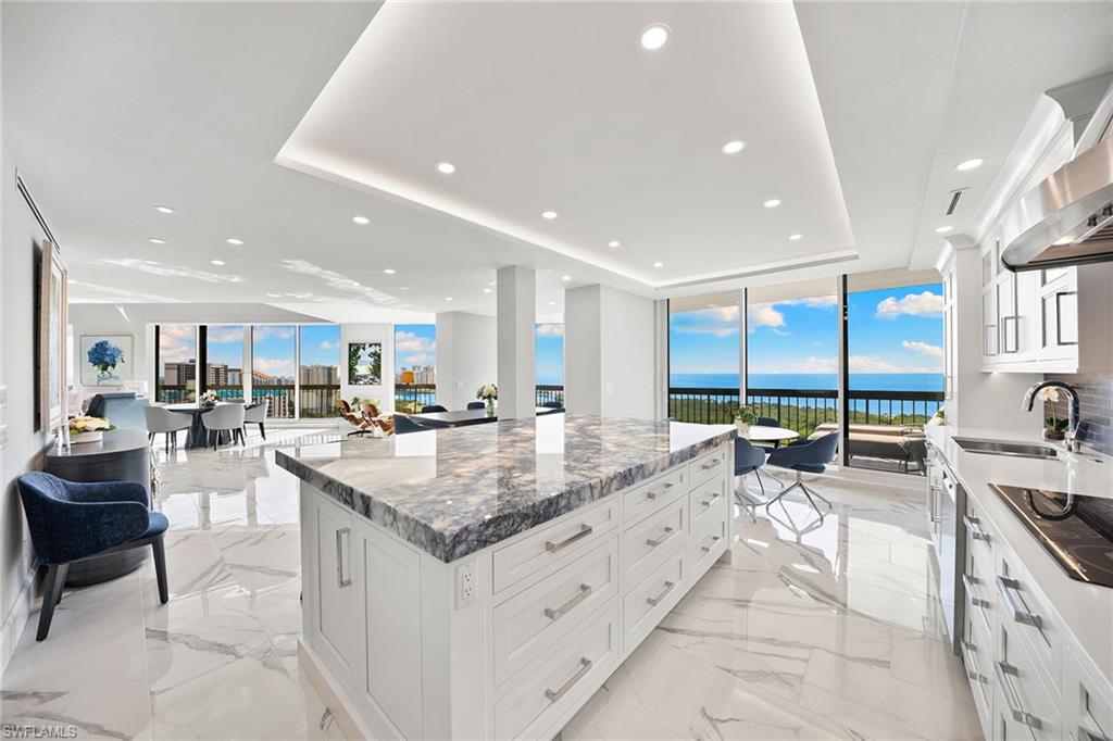 6001 Pelican Bay Boulevard, Unit PHA Naples, FL 34108 - Photo 26 of 50 a kitchen with counter top space and a sink