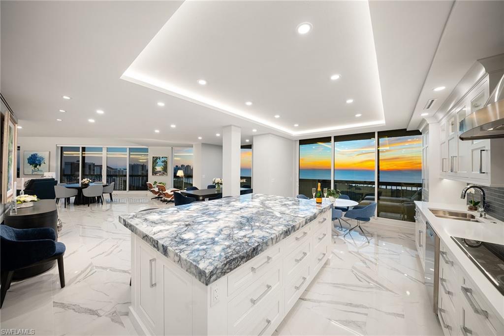 6001 Pelican Bay Boulevard, Unit PHA Naples, FL 34108 - Photo 3 of 50 a view of a kitchen with kitchen island granite countertop a large window