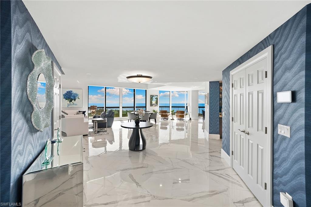 6001 Pelican Bay Boulevard, Unit PHA Naples, FL 34108 - Photo 32 of 50 a view of a livingroom with furniture and white walls