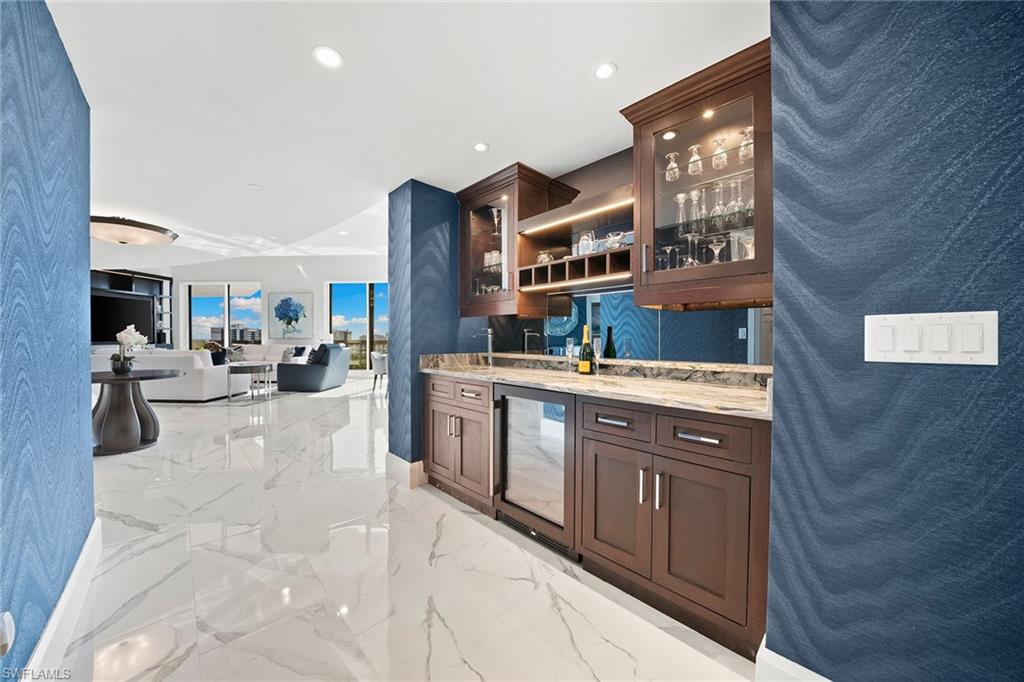 6001 Pelican Bay Boulevard, Unit PHA Naples, FL 34108 - Photo 33 of 50 a lobby with furniture and a tub