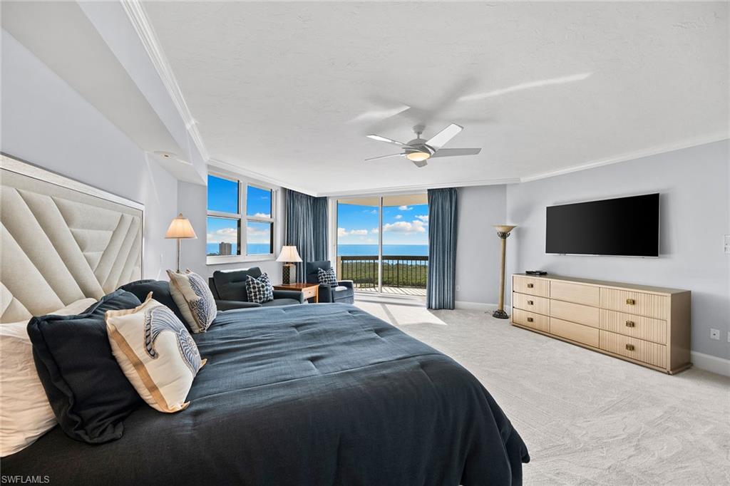 6001 Pelican Bay Boulevard, Unit PHA Naples, FL 34108 - Photo 40 of 50 a bedroom with furniture and flat screen tv