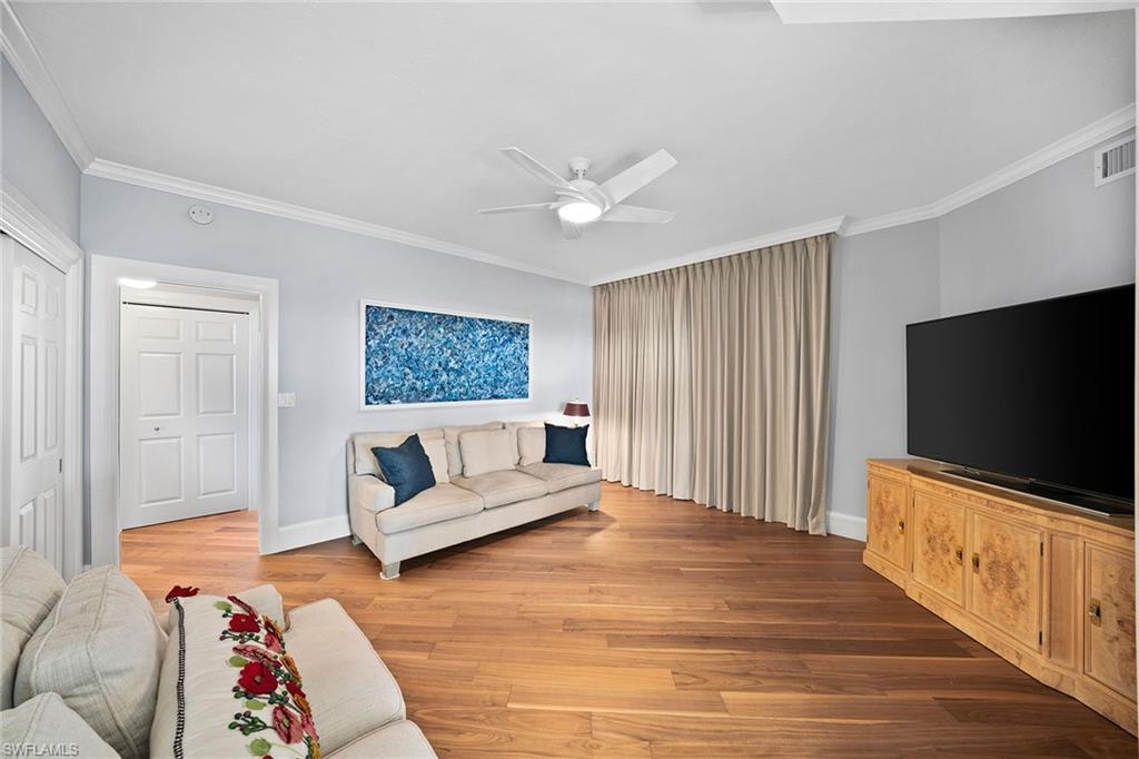 6001 Pelican Bay Boulevard, Unit PHA Naples, FL 34108 - Photo 45 of 50 a living room with furniture and a flat screen tv