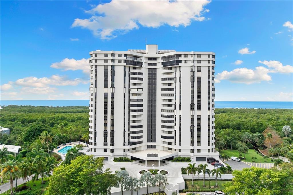 6001 Pelican Bay Boulevard, Unit PHA Naples, FL 34108 - Photo 46 of 50 a view of a large building with a yard