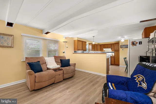 a living room with furniture and kitchen view