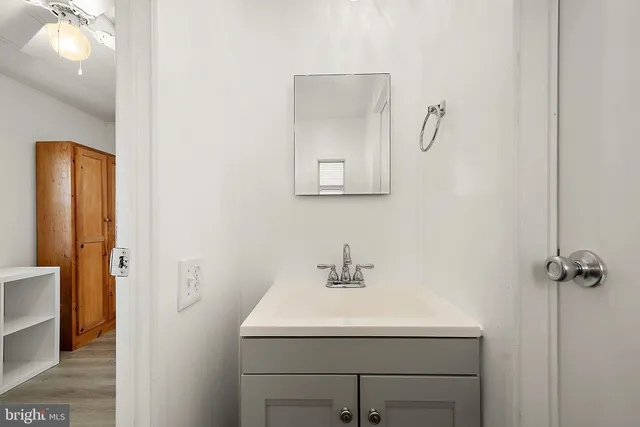 a bathroom with a sink and mirror