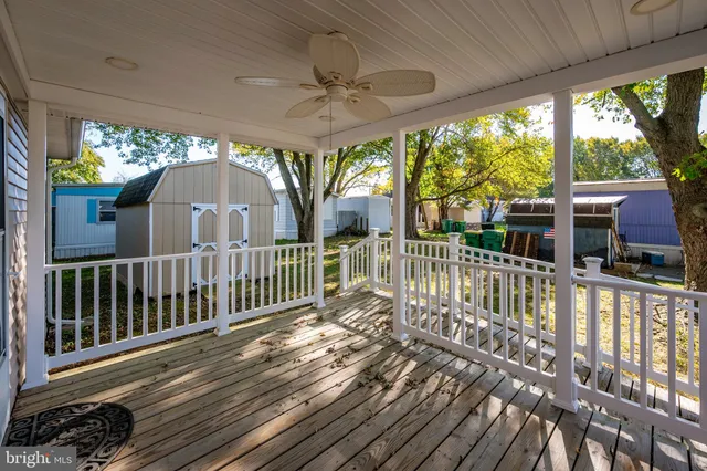 a view of a porch with wooden floor and furniture