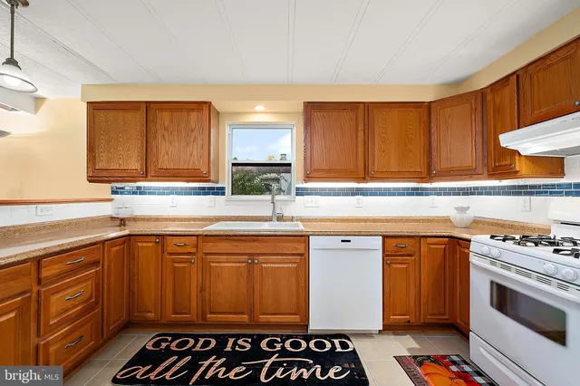 a kitchen with a sink stove and microwave