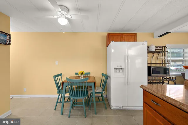 a dining room with furniture and a kitchen view
