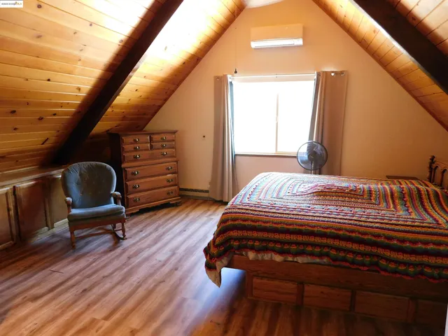 a bathroom with a granite countertop toilet sink and mirror