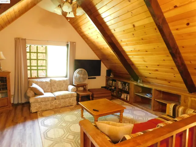a balcony with wooden floor and outdoor seating