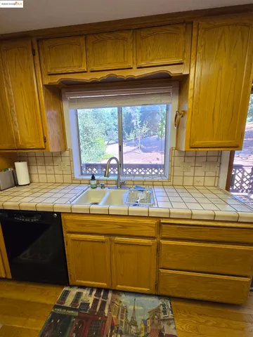a view of a kitchen with furniture window and wooden floor