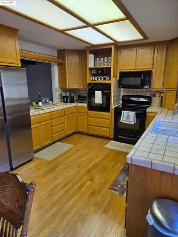 a living room with furniture tv and wooden floor