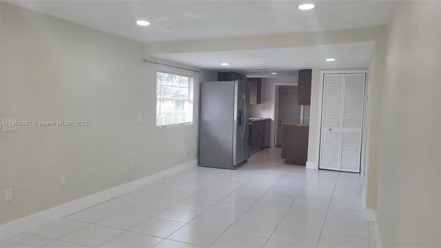 an empty room with windows and entrance